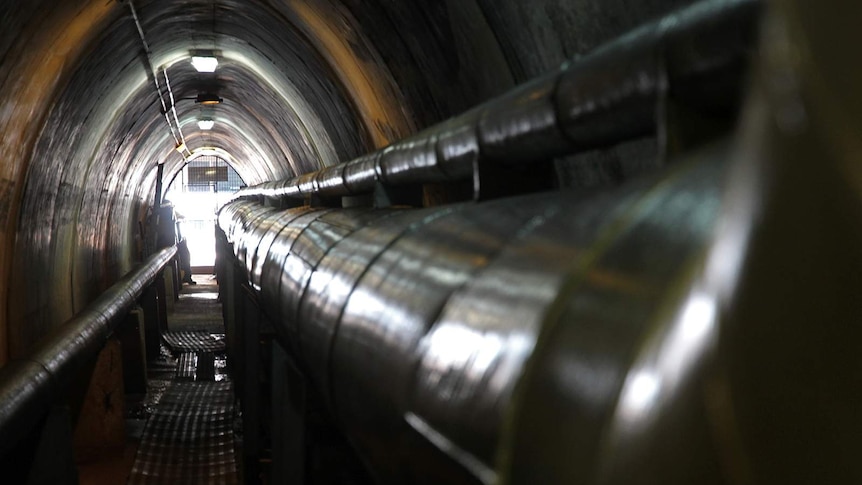 A photo through the storage tunnels, with the view of a tunnel on the side.