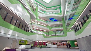 A wide shot of the interior atrium at the new Perth Children's Hospital, looking up at the upper levels.