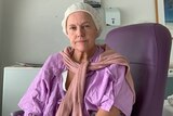 Woman in purple hospital gown.