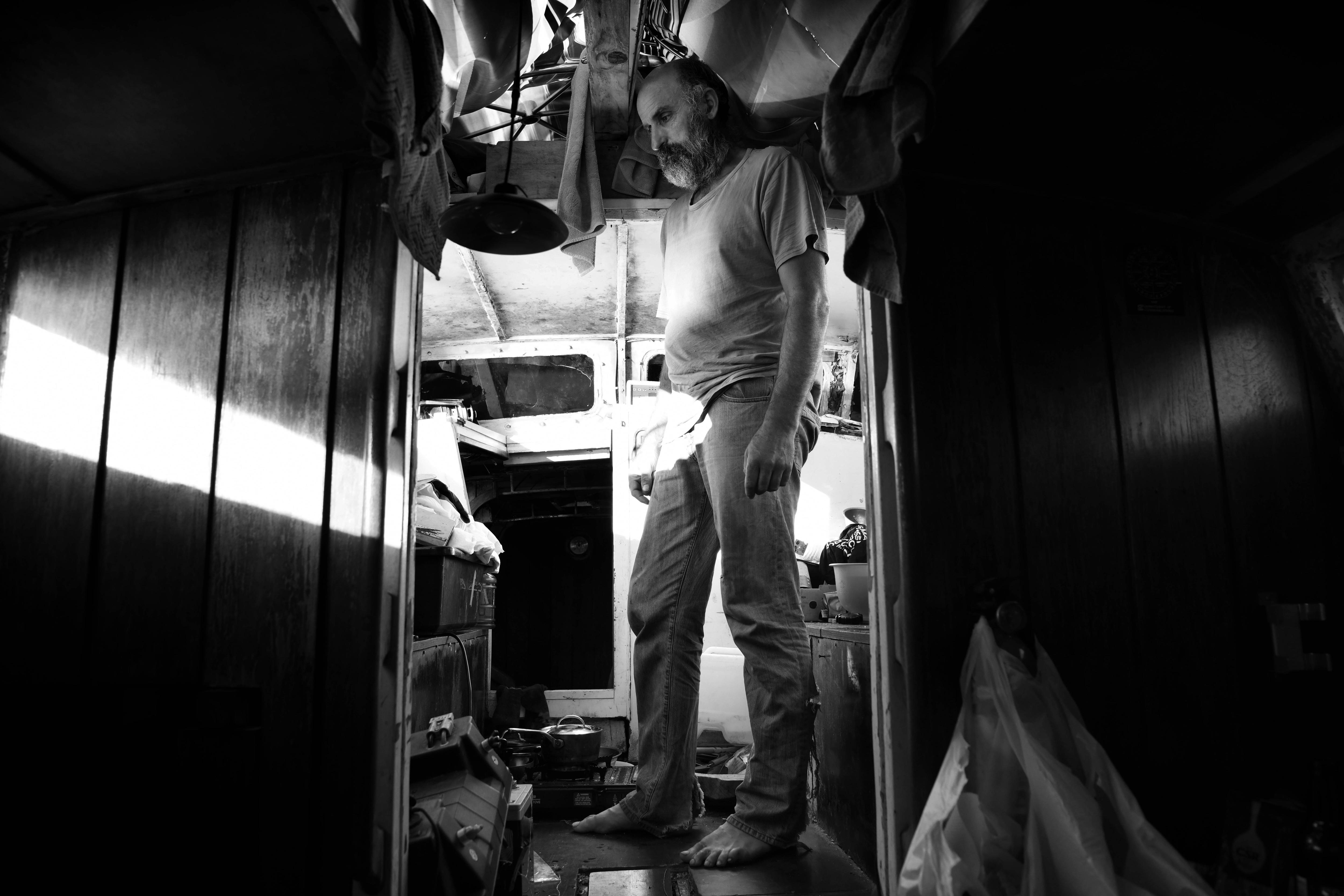 A man stands inside a confined space 