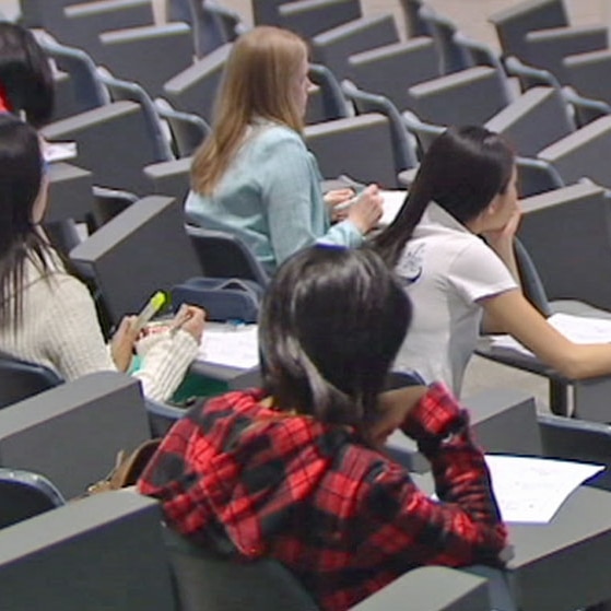 Students sitting in lecture hall.