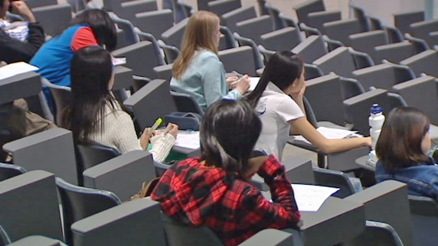 Video still: University students sitting in a lecture theatre