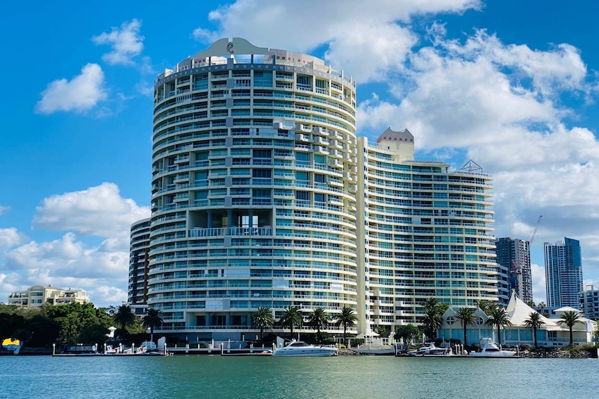 A high-rise apartment building on a waterfront.