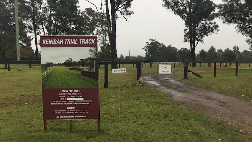 A country property with a sign showing an image of a race track.