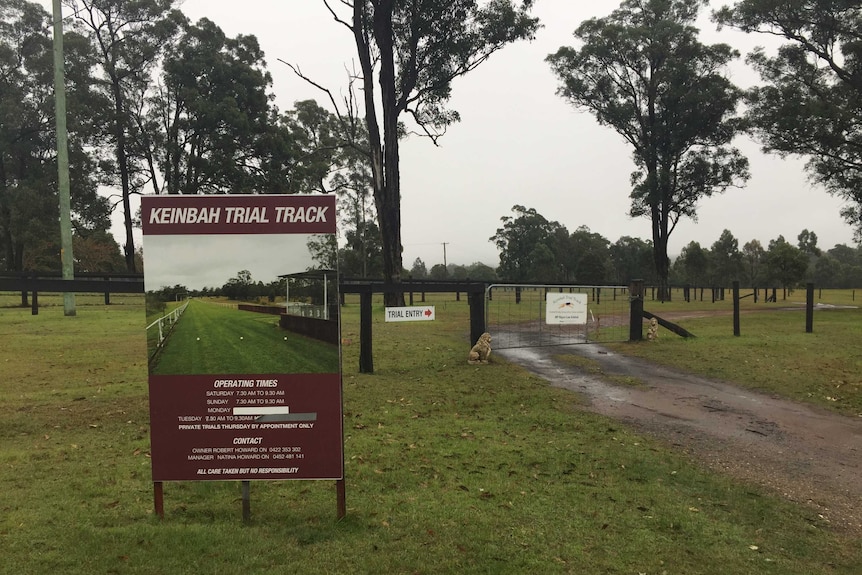 A country property with a sign showing an image of a race track.