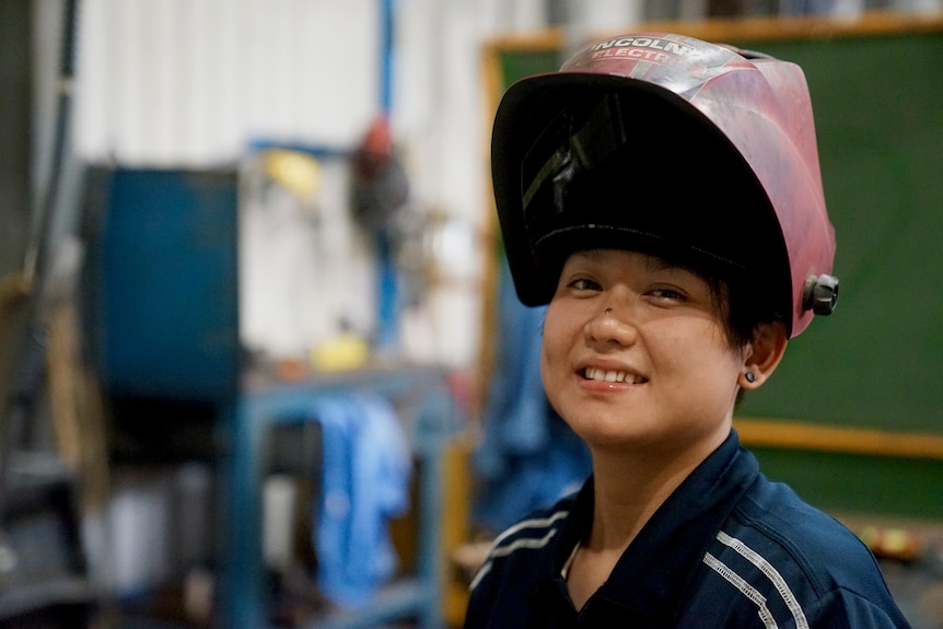 Sayray wearing a welder's mask on her head.