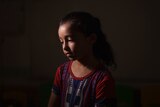 Maya Abu Muawad, 8, poses for a portrait at a school run by the United Nations