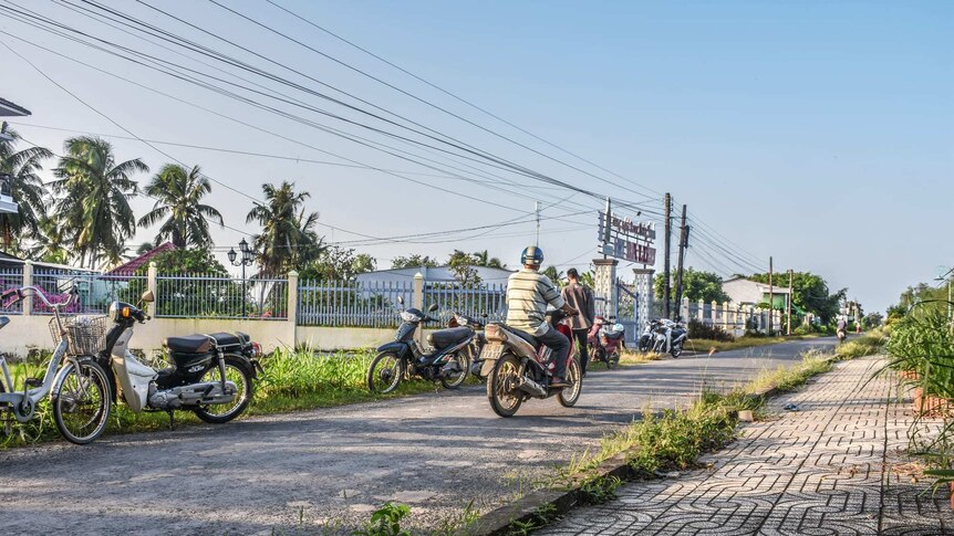 Nguyen Quoc Thanh rides his bike between his four worksites.