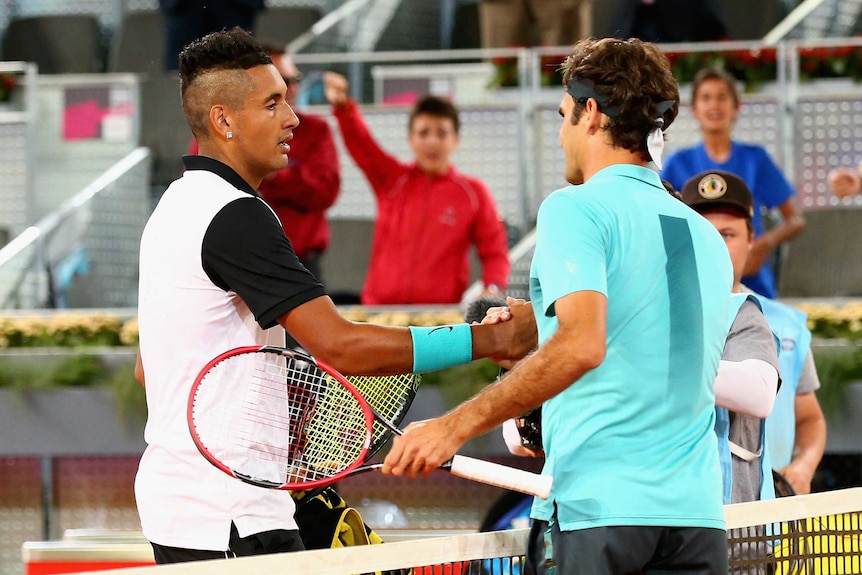 Nick Kyrgios and Roger Federer shake hands after their match at the Madrid Masters