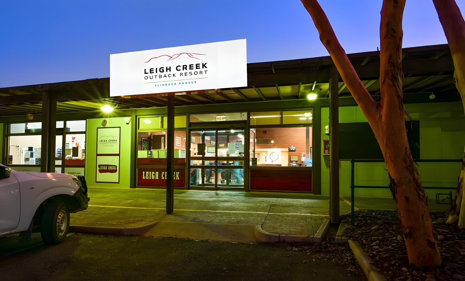 A one-storey building saying Leigh Creek Outback Resort, pictured at night.