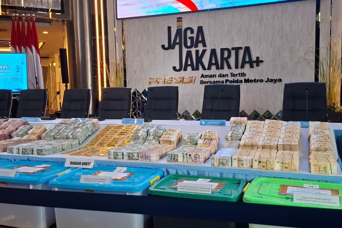 Stacks of gold bars and bank notes set out on a table.