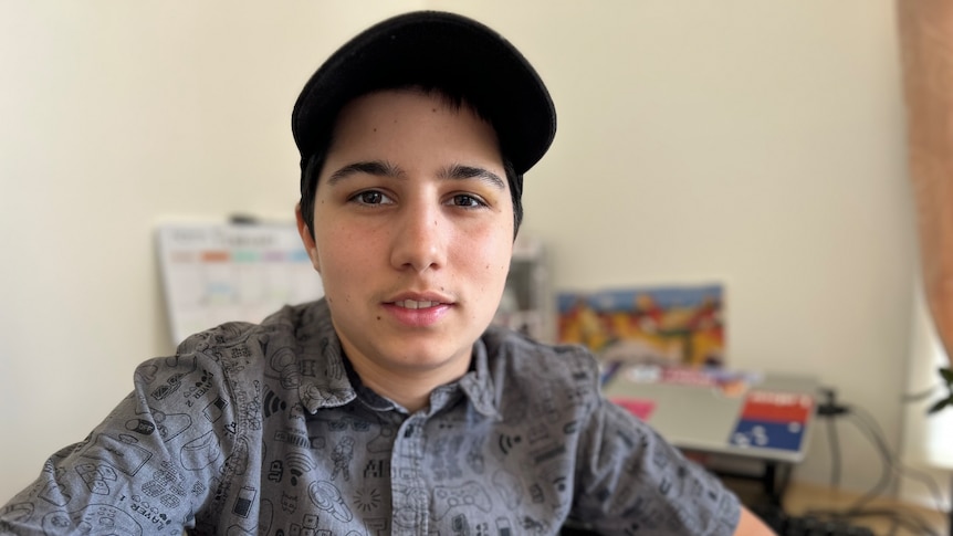 Young man in button-up shirt and cap