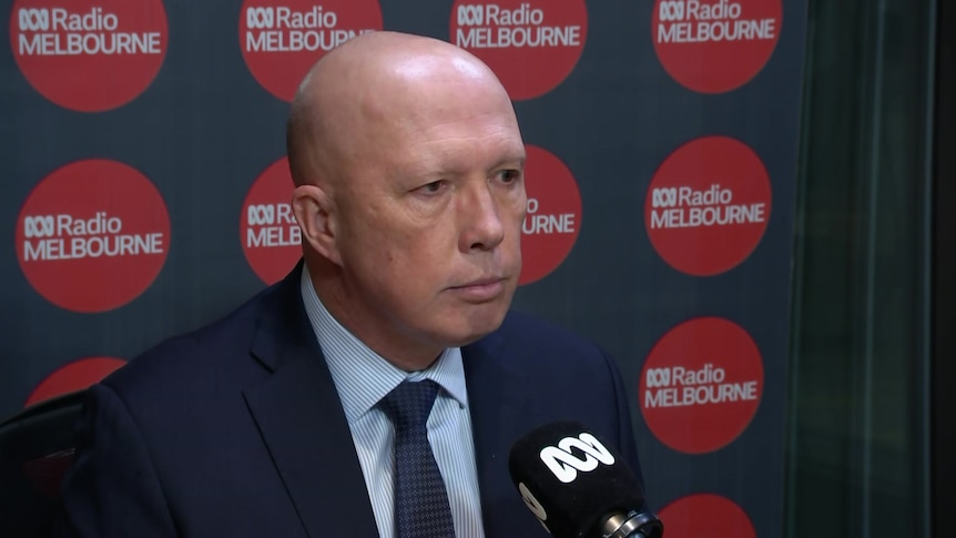 Peter Dutton seated in front of ABC branded microphone with ABC Radio Melbourne branding behind.