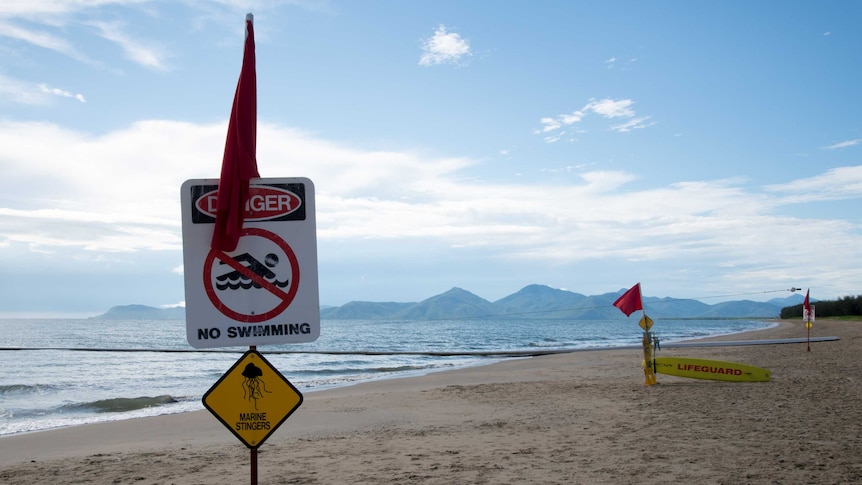 Warning signs telling swimmers not to go in the water.