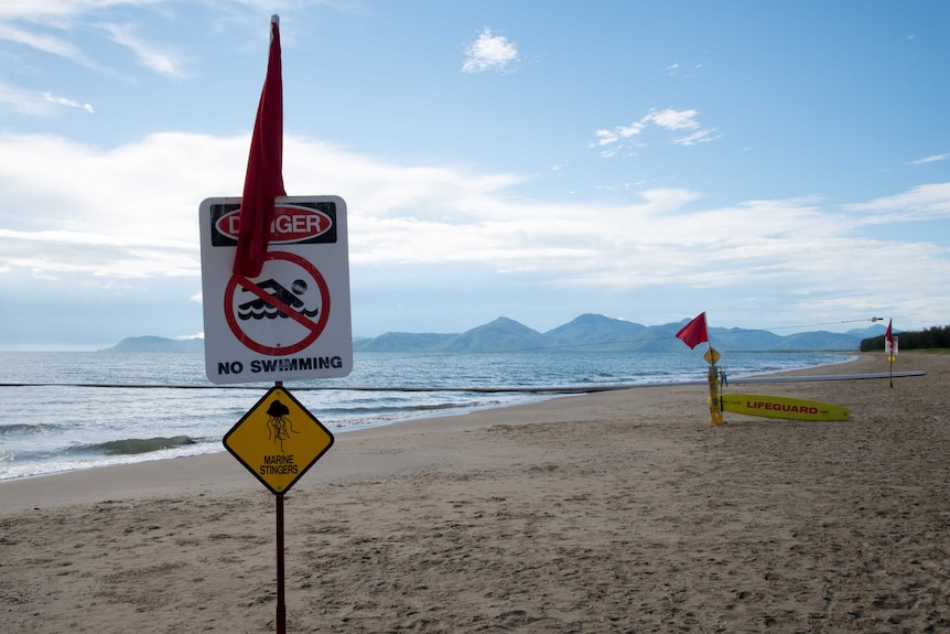 Warning signs telling swimmers not to go in the water.