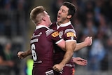 Ben Hunt of the Maroons celebrates with Tom Dearden with a hug after scoring