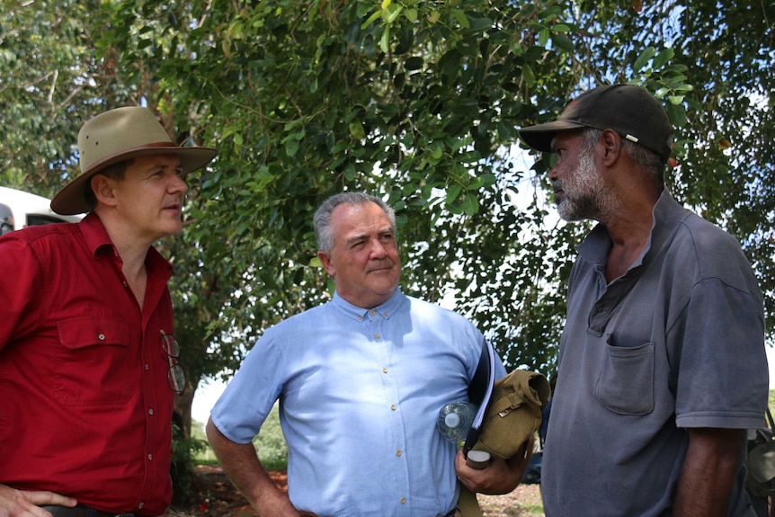 Chief Minister Michael Gunner and Housing Minister Gerry McCarthy speak to Milikapiti resident Joseph Tweedy Henry.