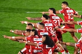 Tongan rugby league players point in unison during a kailao before a rugby league Test against New Zealand.