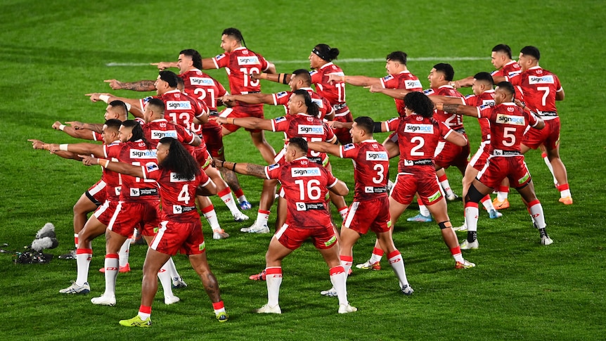 Tongan rugby league players point in unison during a kailao before a rugby league Test against New Zealand.