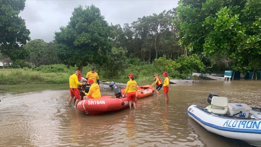 A group of SES volunteers ready boats in floodwaters