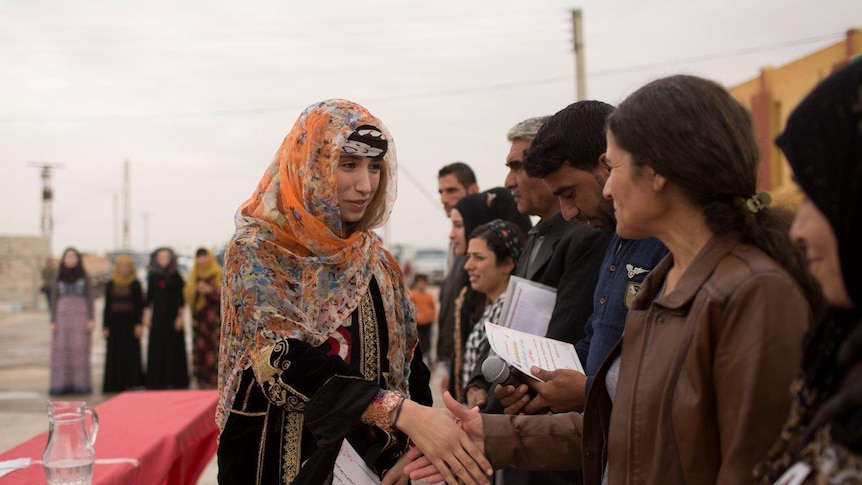 A female student with a graduation certificate shakes hands with workshop leader