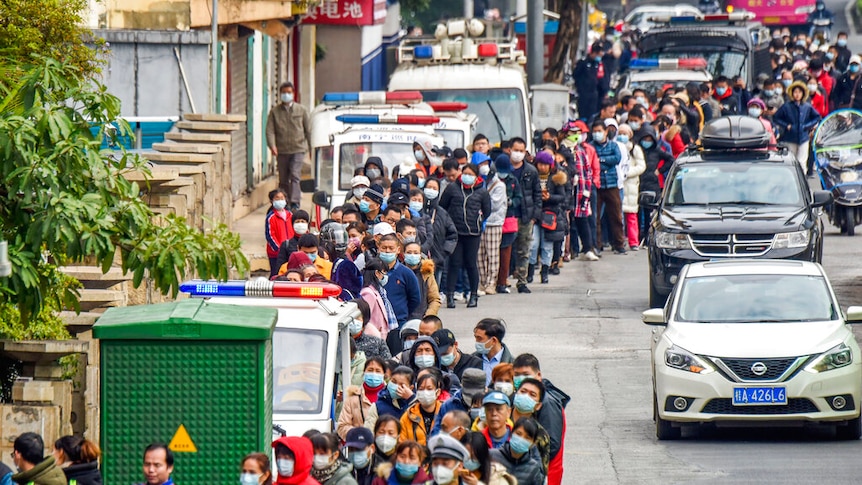 Hundreds with face masks lined up to buy face masks in southern China.