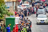 Hundreds with face masks lined up to buy face masks in southern China.
