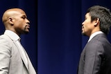 Floyd Mayweather (L) and Manny Pacquiao face off at press conference promoting their fight.