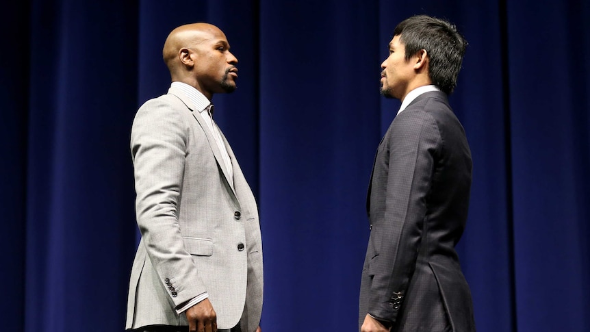Floyd Mayweather (L) and Manny Pacquiao face off at the start of their Press Conference promoting their upcoming fight