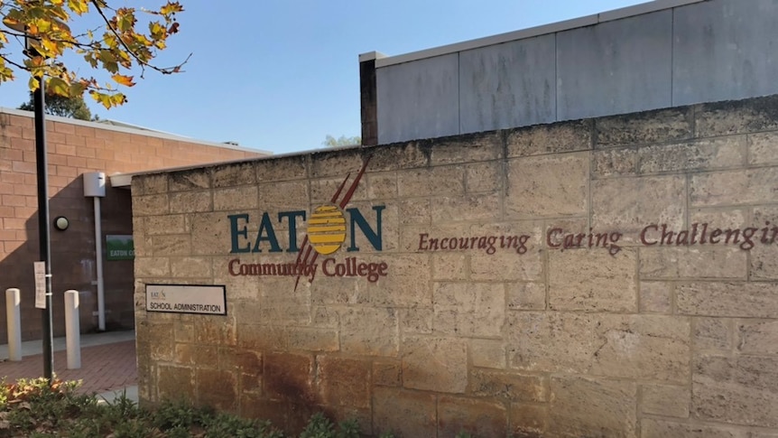 A picture of a limestone wall with Eaton Community College with Encouraging, Caring, Challenging