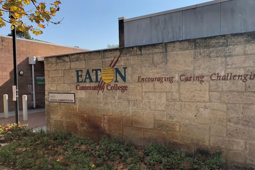 A picture of a limestone wall with Eaton Community College with Encouraging, Caring, Challenging