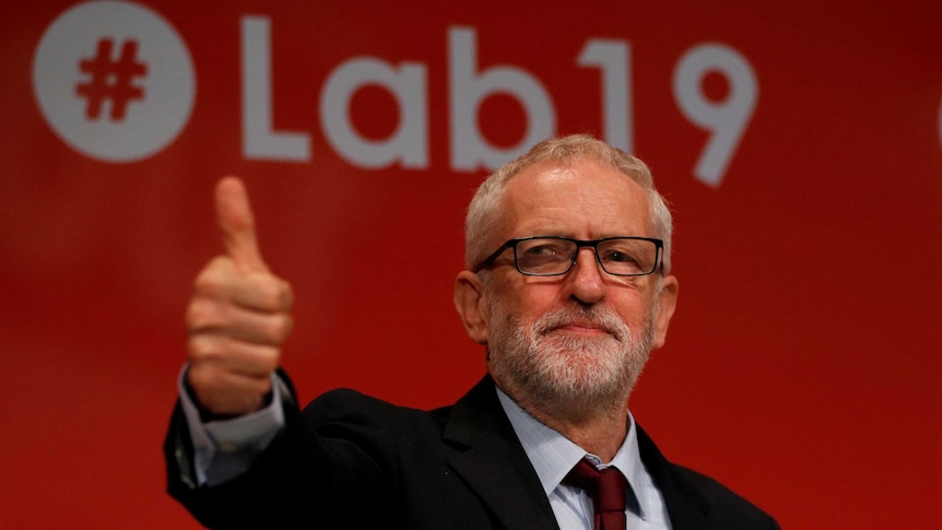 Jeremy Corbyn smiles and gives a thumbs up.