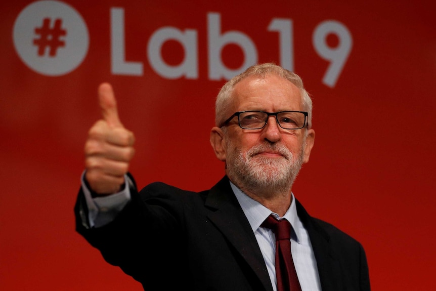 Jeremy Corbyn smiles and gives a thumbs up.