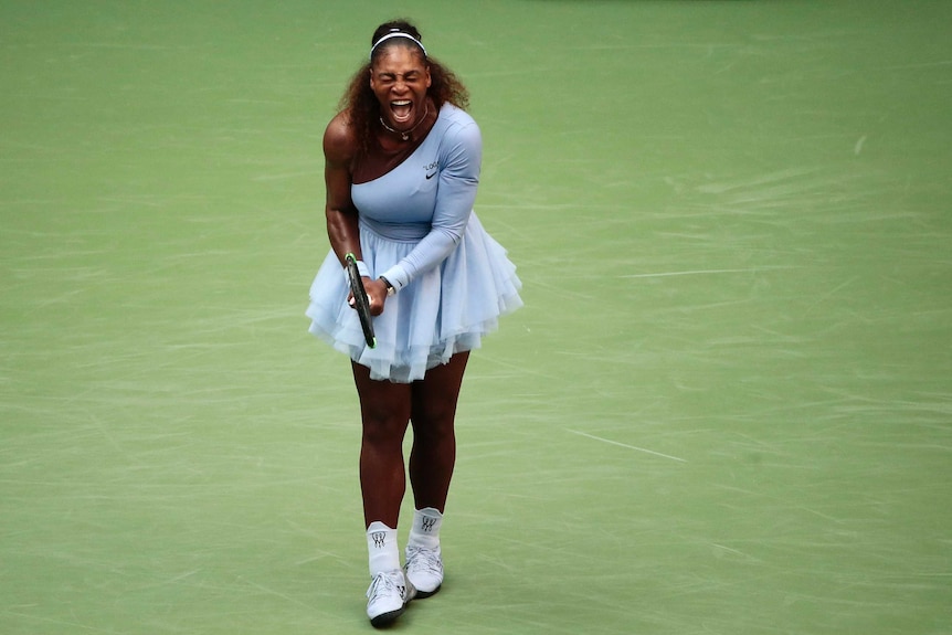 A female tennis player screams while wearing a purple tutu