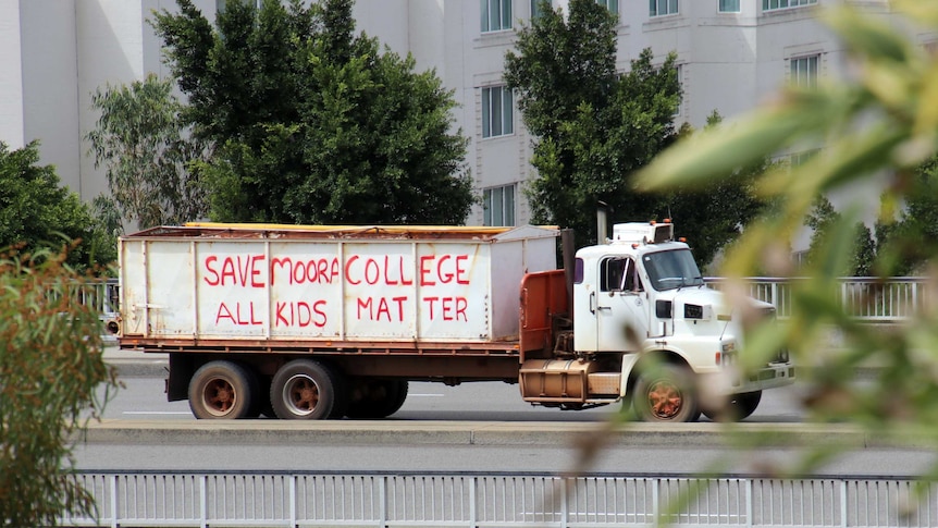 A truck with the message "Save Moora College" written on the side.