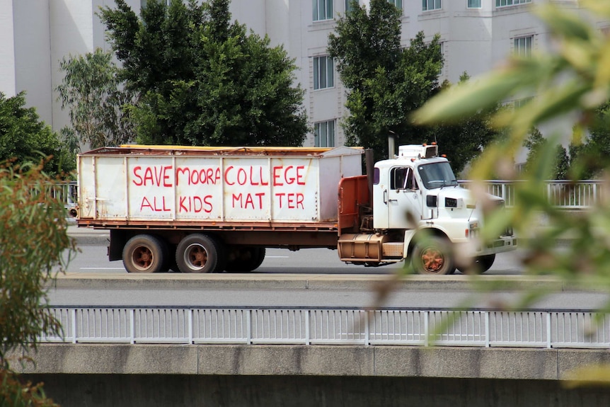 A truck with the message "Save Moora College" written on the side.