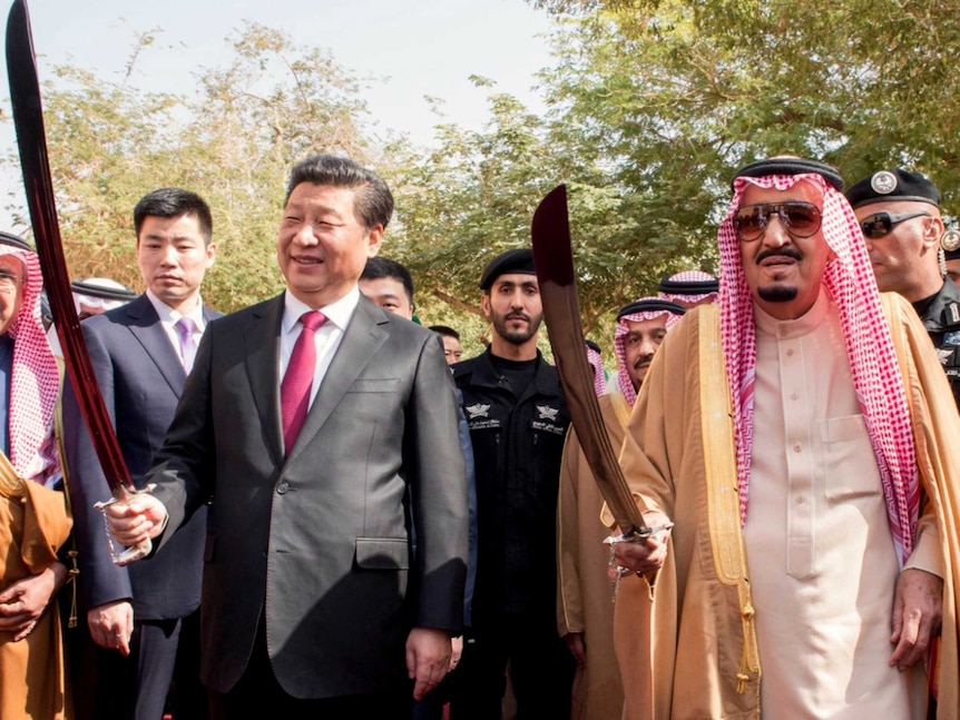Saudi King Salman bin Abdulaziz and Chinese President Xi Jinping perform a traditional dance with swords.
