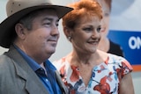 One Nation leader Pauline Hanson (right) poses with a man a a One Nation event.