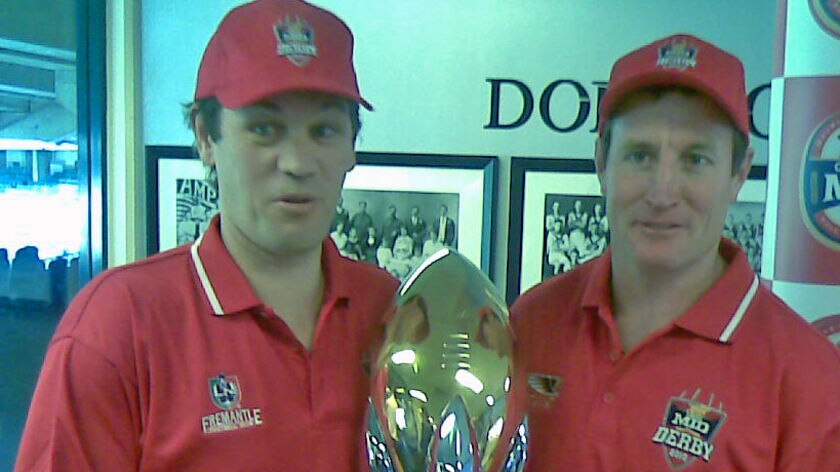 Dockers coach Mark Harvey and Eagles coach John Worsfold hold onto the derby cup