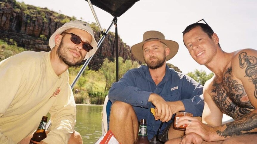 Three men sitting on a boat in the Kimberley 