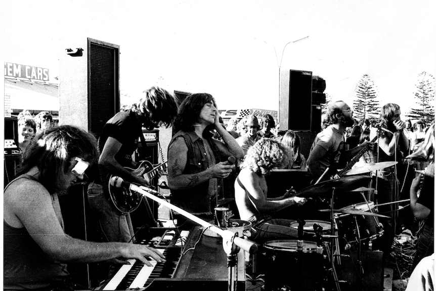 Black and white photo of a 1970s rock band on stage