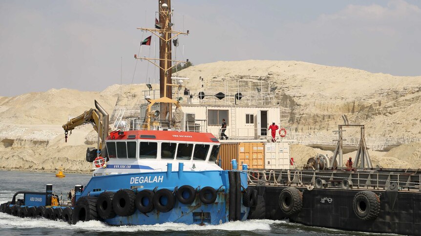A boat is pictured as construction continues on Egypt's New Suez Canal project at the Suez Canal zone, Egypt, June 13, 2015