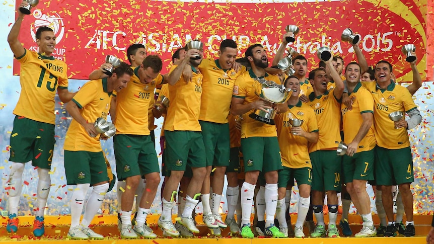 Socceroos celebrate with Asian Cup trophy