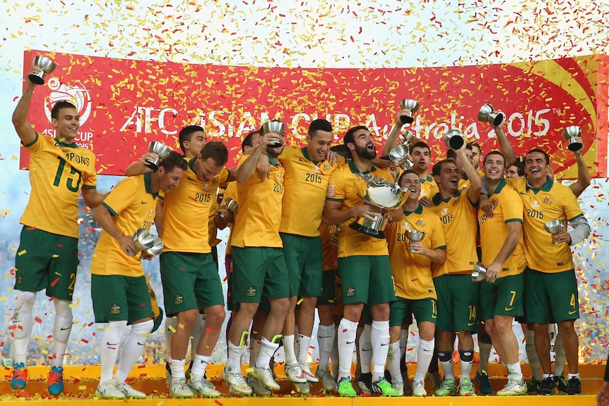 Socceroos celebrate with Asian Cup trophy