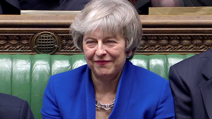 British Prime Minister Theresa May smiles after she won a confidence vote in Parliament.