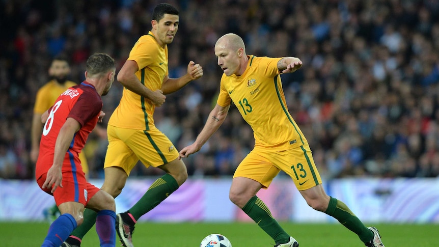 Aaron Mooy dribbles the ball against England