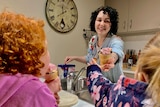 Melissa McDowell serves ice-cream to her two daughters.