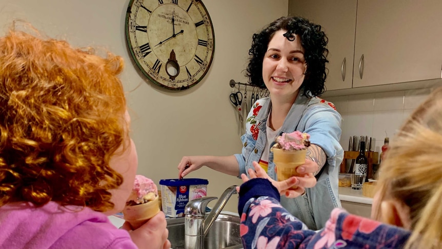 Melissa McDowell serves ice-cream to her two daughters.