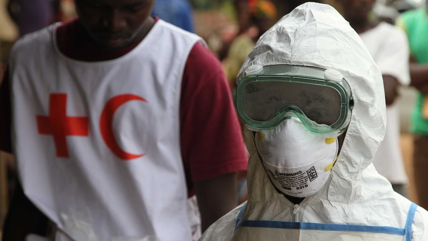 Red Cross volunteer and worker in protective clothing