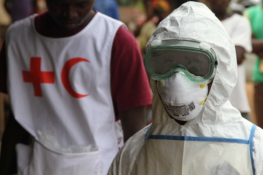 Red Cross volunteer and worker in protective clothing